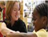 Photographic image of a teacher and student