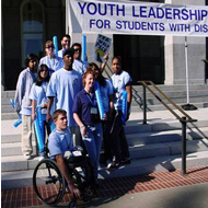 Student posing for a picture on the steps of the Youth Leadership Forum  venue