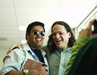 A photograph of a mentor and a young man laughing (from the California Youth Leadership Forum)